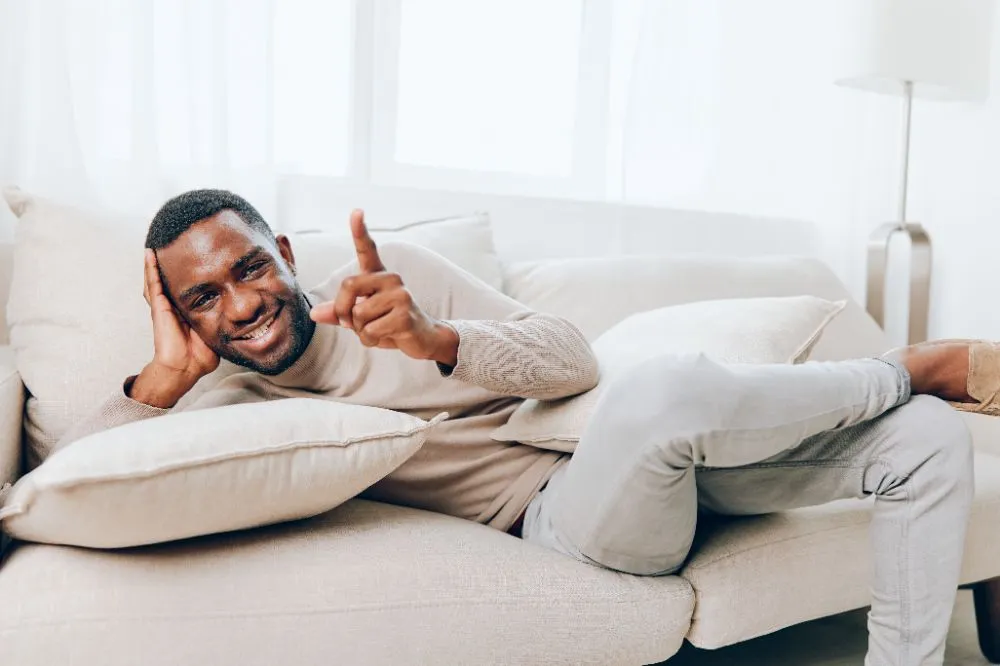 relaxed man sitting on a modern couch